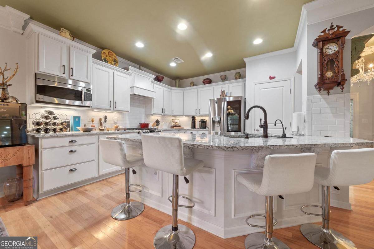 1151 Spring Station Road Greensboro, GA 30642 - Photo 17 of 60 a kitchen with stainless steel appliances granite countertop a sink and cabinets