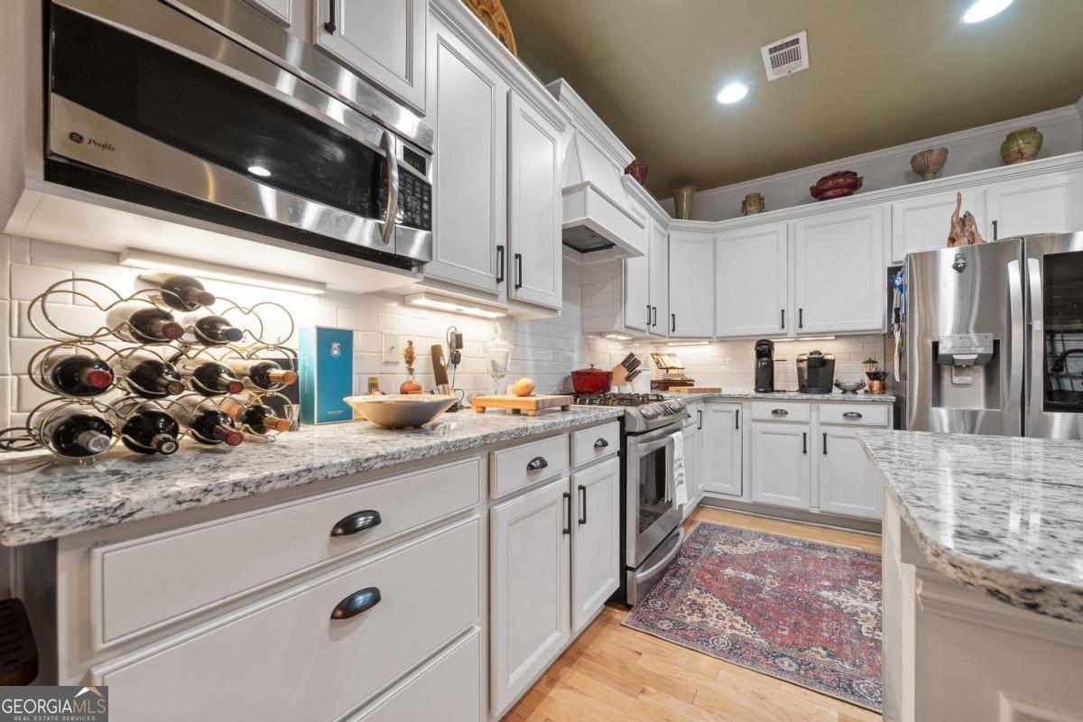 1151 Spring Station Road Greensboro, GA 30642 - Photo 18 of 60 a kitchen with stainless steel appliances granite countertop a sink and a stove