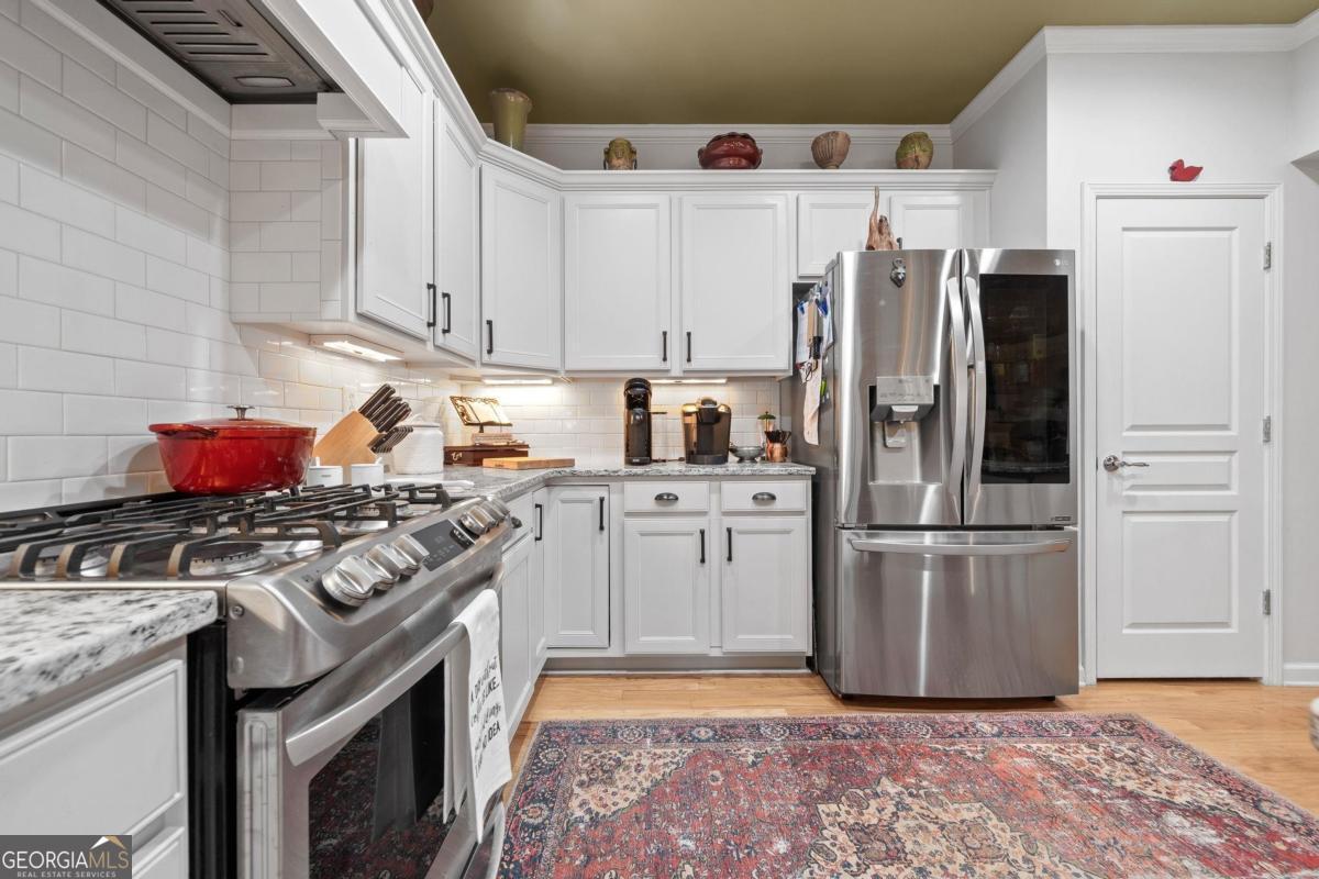 1151 Spring Station Road Greensboro, GA 30642 - Photo 19 of 60 a kitchen with a stove top oven and refrigerator