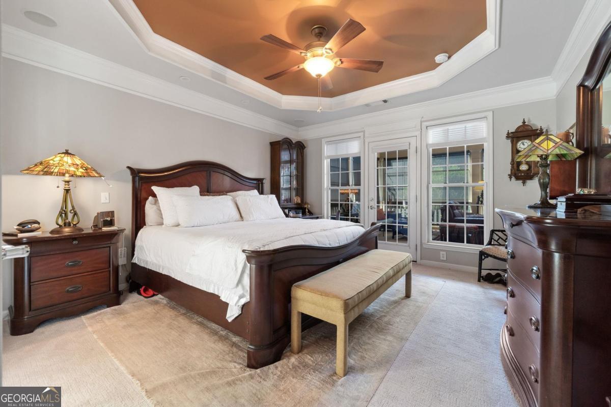 1151 Spring Station Road Greensboro, GA 30642 - Photo 23 of 60 a bed room with a bed and a chandelier