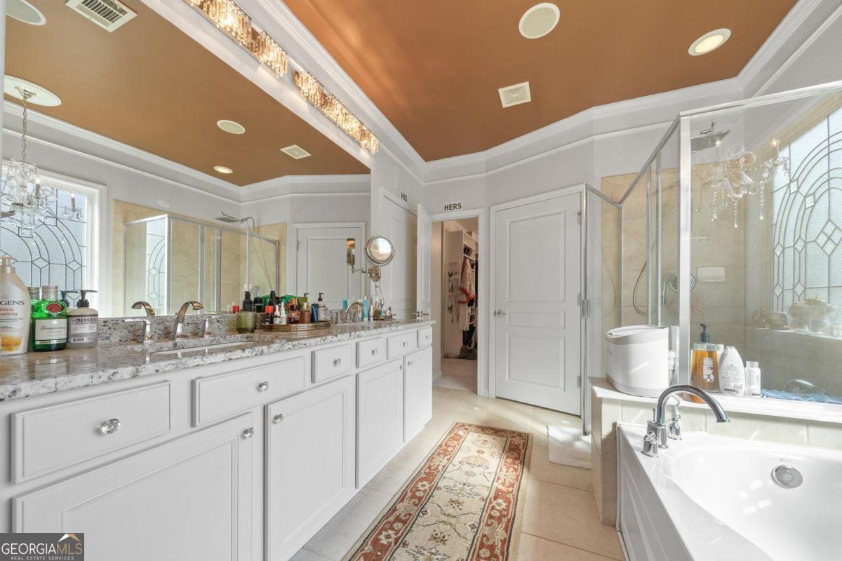 1151 Spring Station Road Greensboro, GA 30642 - Photo 26 of 60 a bathroom with double vanity sinks a large mirror and a shower