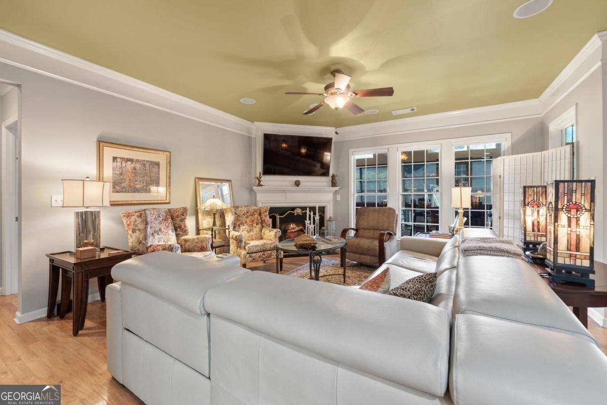 1151 Spring Station Road Greensboro, GA 30642 - Photo 3 of 60 a living room with furniture a flat screen tv and a fireplace