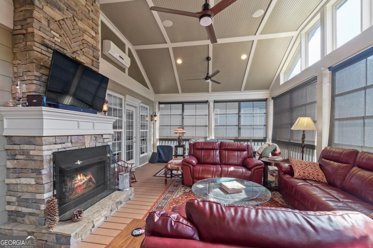 1151 Spring Station Road Greensboro, GA 30642 - Photo 4 of 60 a living room with furniture a flat screen tv and a fireplace