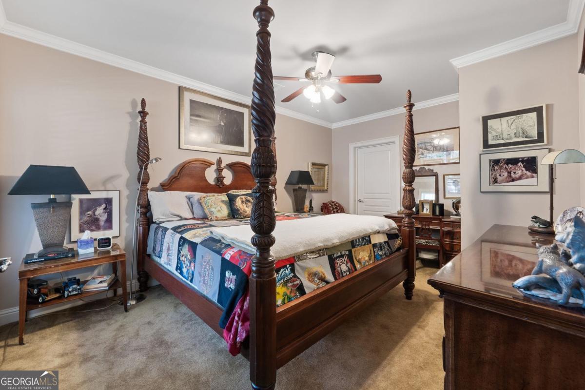 1151 Spring Station Road Greensboro, GA 30642 - Photo 50 of 60 a bedroom with a bed a dresser and potted plants