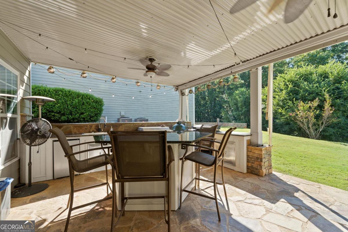 1151 Spring Station Road Greensboro, GA 30642 - Photo 54 of 60 a view of a patio with a table chairs and a backyard