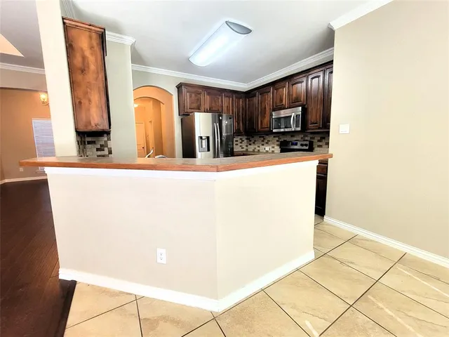 a view of a kitchen with kitchen island wooden floor and window