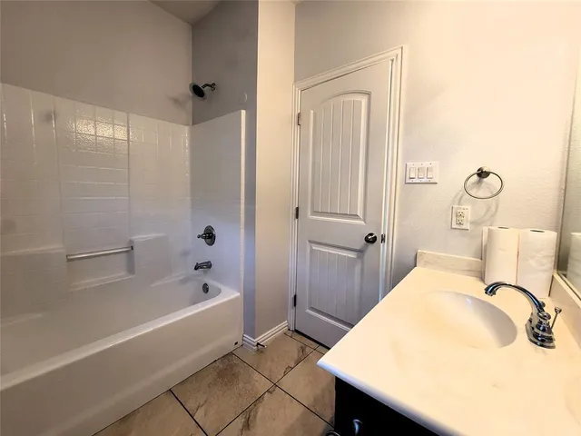 a bathroom with a bathtub and shower