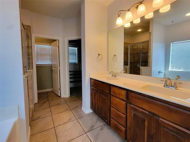 a spacious bathroom with a double vanity sink and a mirror