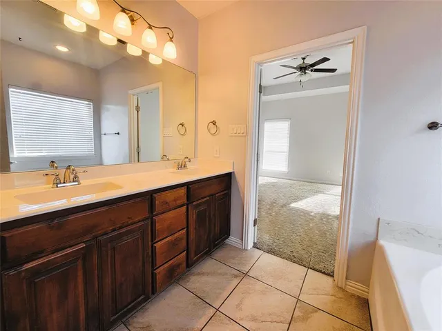a spacious bathroom with a double vanity sink mirror and