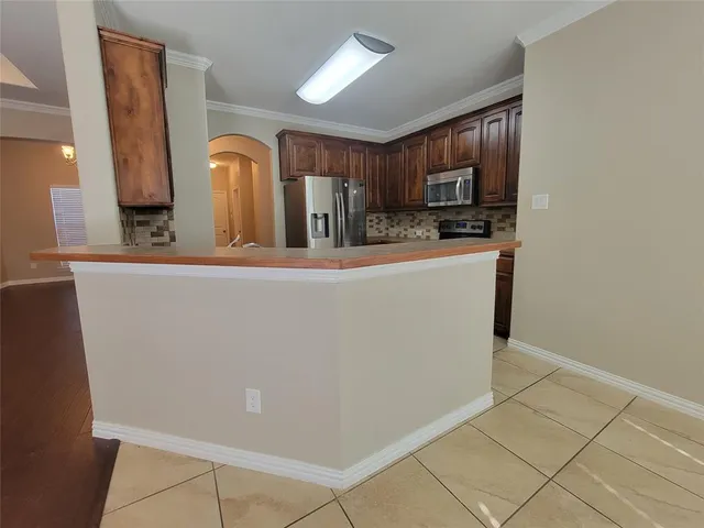 a view of a kitchen with sink and cabinets