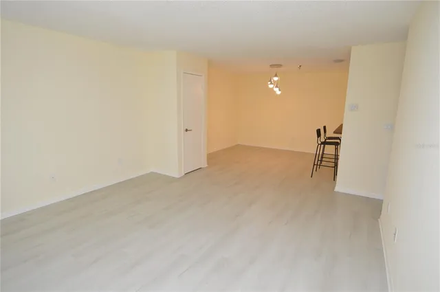 an empty room with a ceiling fan and a window