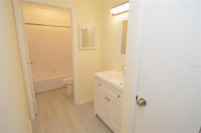 a kitchen with granite countertop a stove a sink a counter top space and cabinets