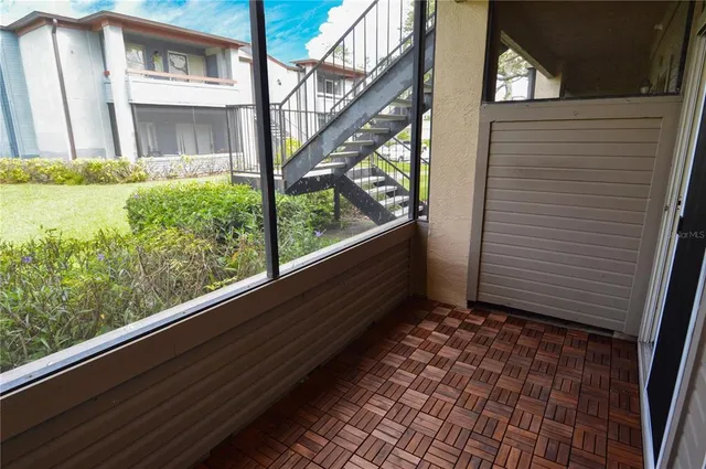 a view of a patio with a table and chairs under an umbrella