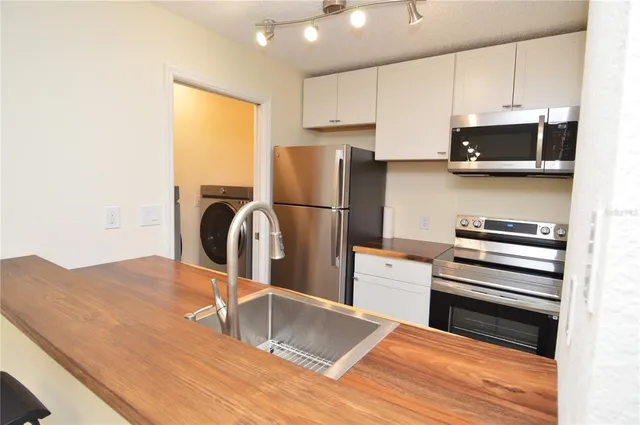 a kitchen with a refrigerator and a stove