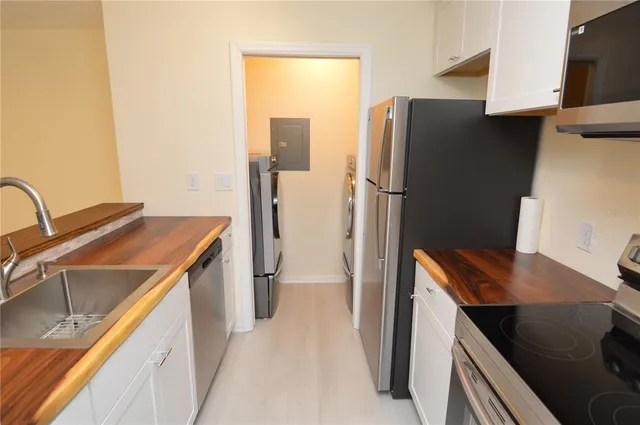 a view of wooden floor and chandelier fan in a room