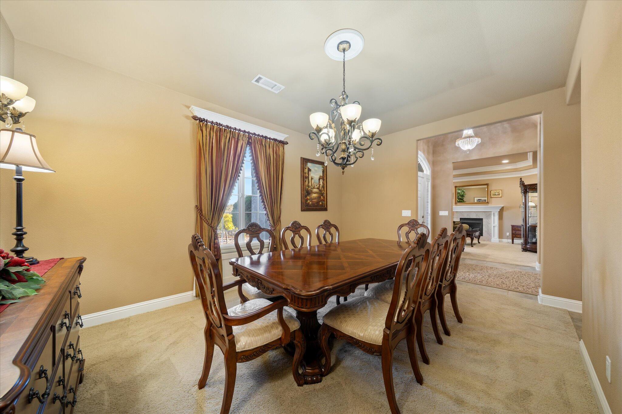 7870 Castle View Lane Redding, CA 96001 - Photo 11 of 65 a dining room with furniture a chandelier and a rug