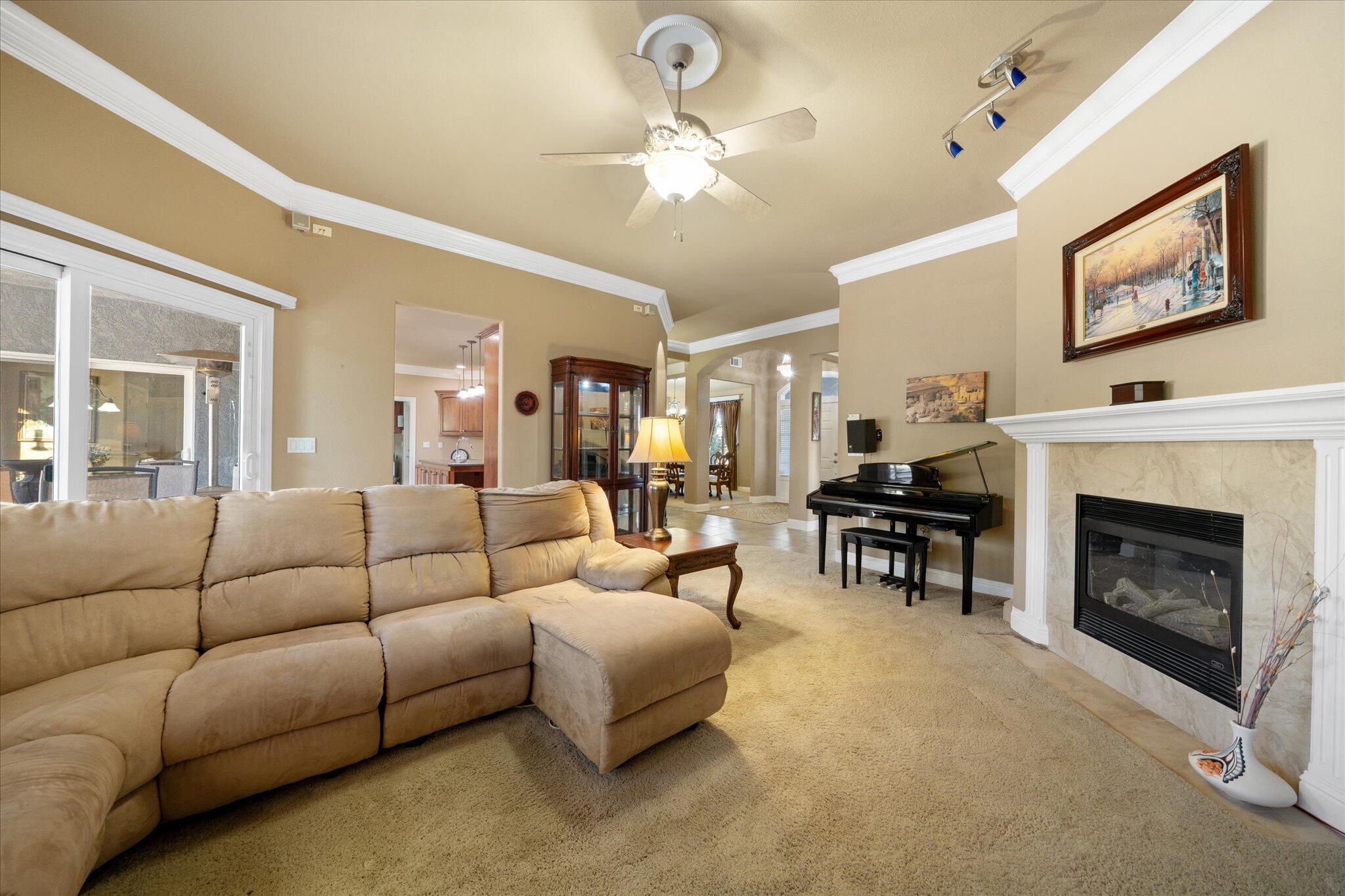 7870 Castle View Lane Redding, CA 96001 - Photo 14 of 65 a living room with furniture a fireplace and a chandelier