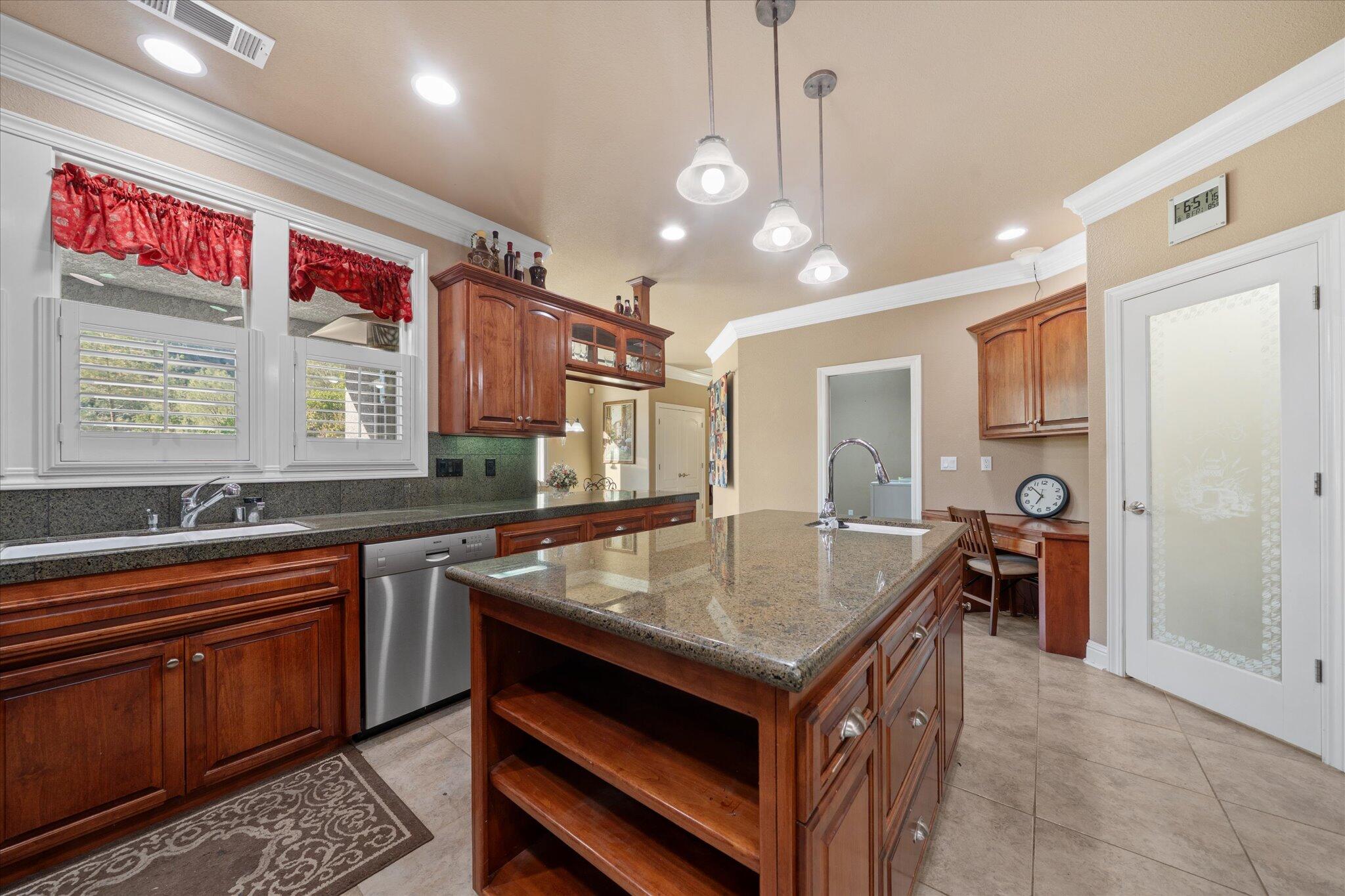 7870 Castle View Lane Redding, CA 96001 - Photo 16 of 65 a kitchen with a stove a refrigerator and a sink