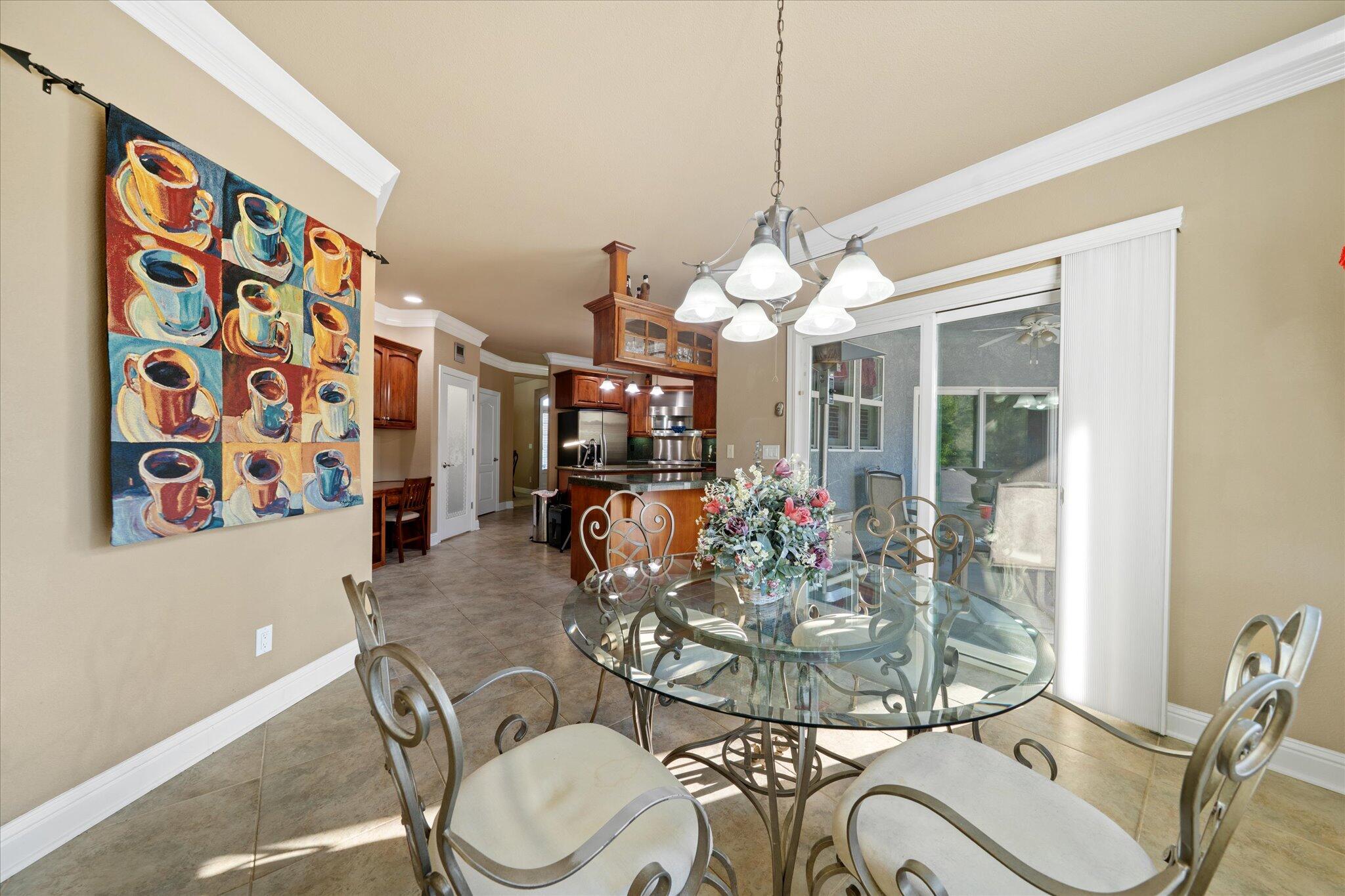 7870 Castle View Lane Redding, CA 96001 - Photo 22 of 65 a view of a dining room with furniture wooden floor and chandelier