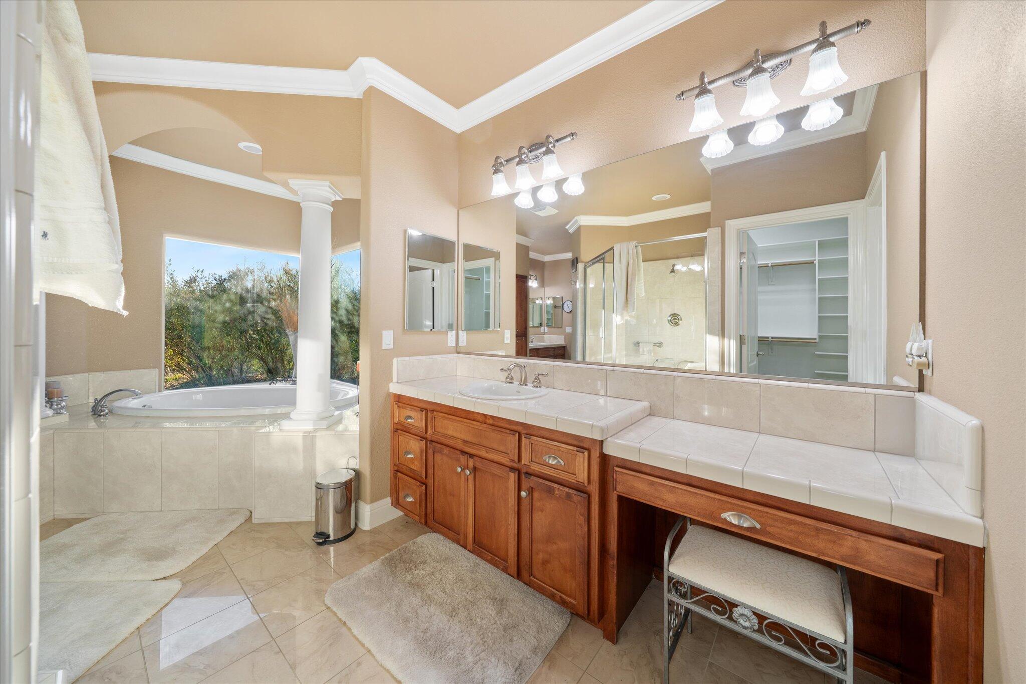 7870 Castle View Lane Redding, CA 96001 - Photo 31 of 65 a spacious bathroom with a granite countertop sink mirror and a bathtub