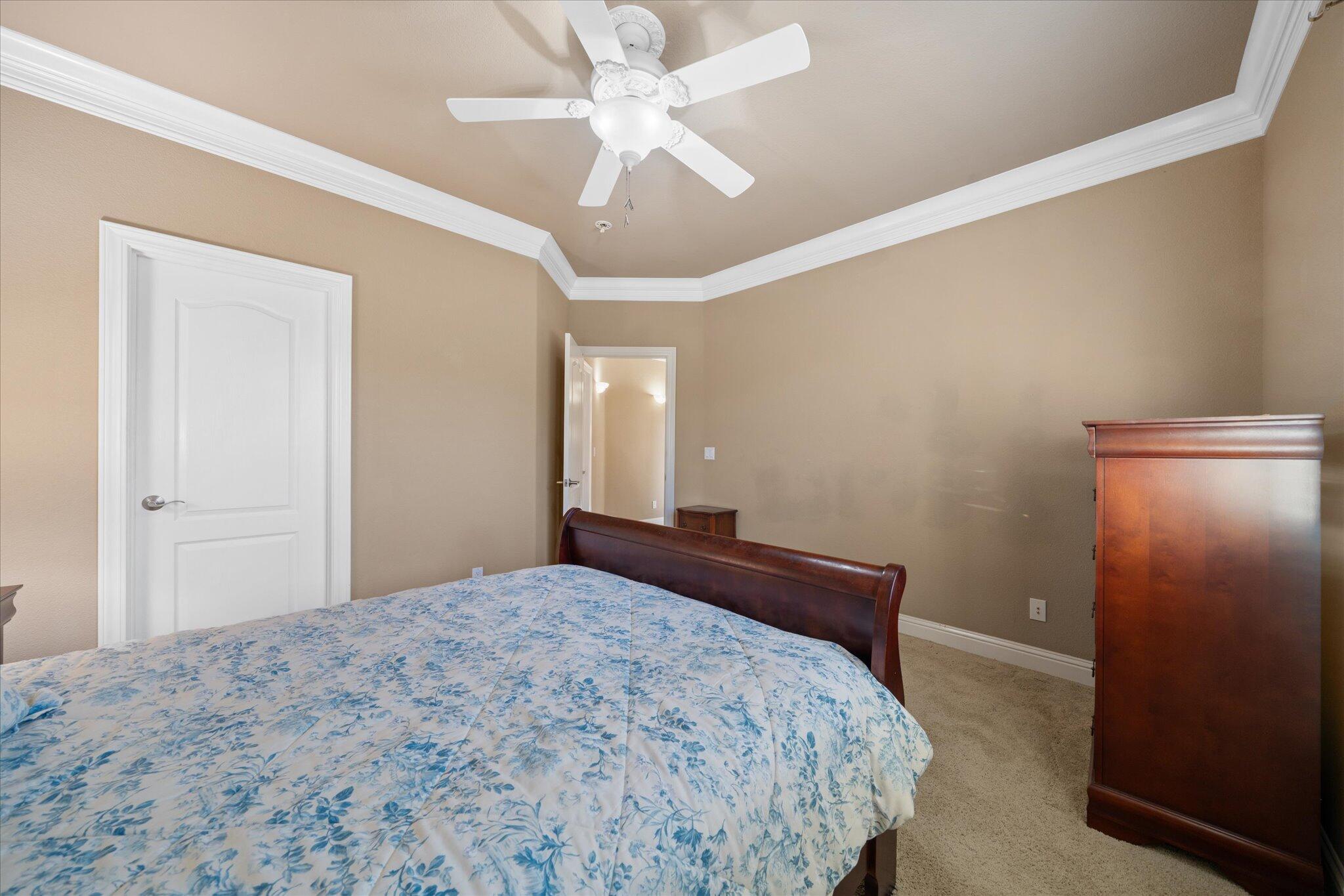 7870 Castle View Lane Redding, CA 96001 - Photo 33 of 65 a bedroom with a bed and a chandelier fan