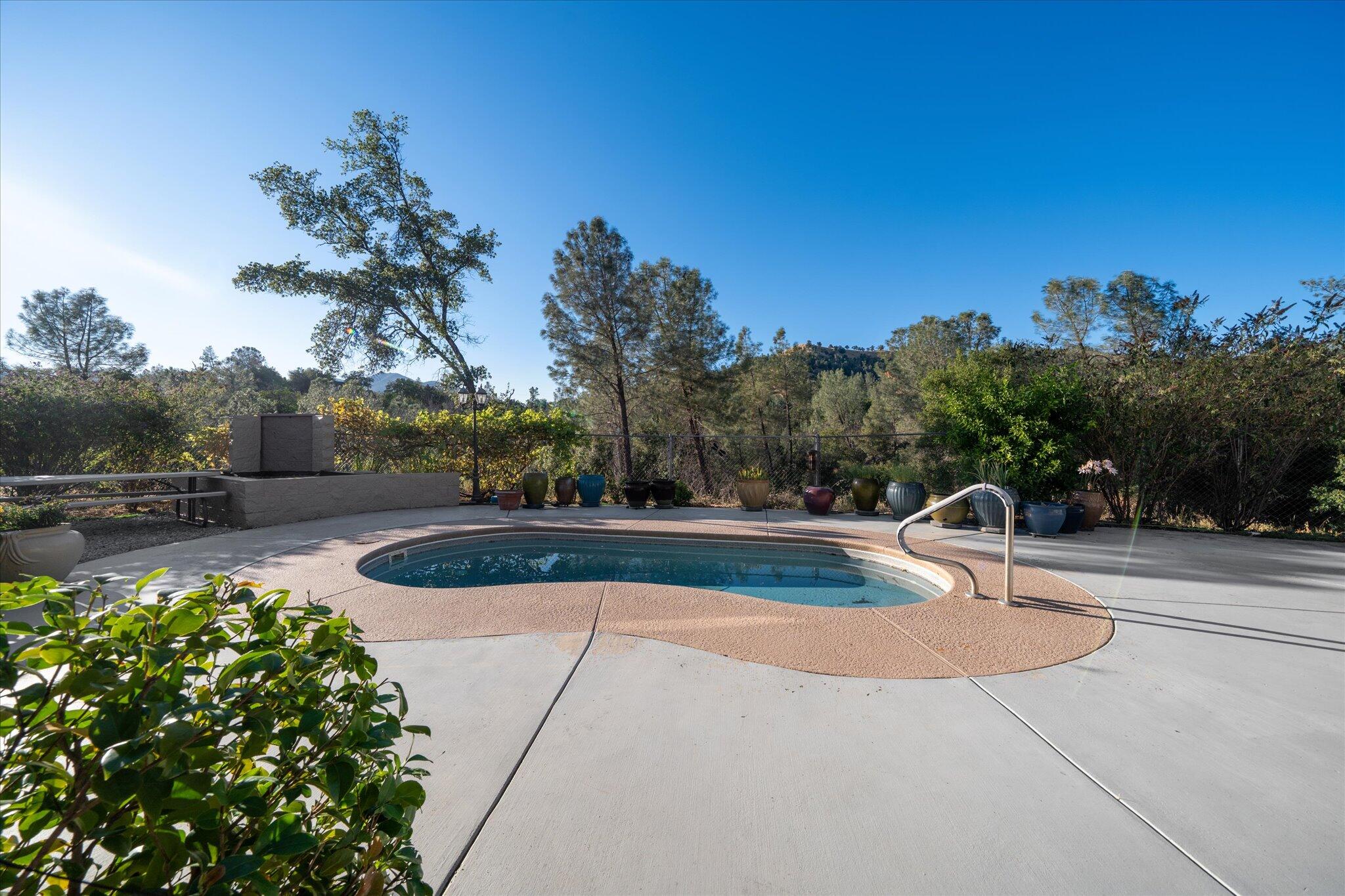 7870 Castle View Lane Redding, CA 96001 - Photo 41 of 65 a view of a swimming pool with a patio