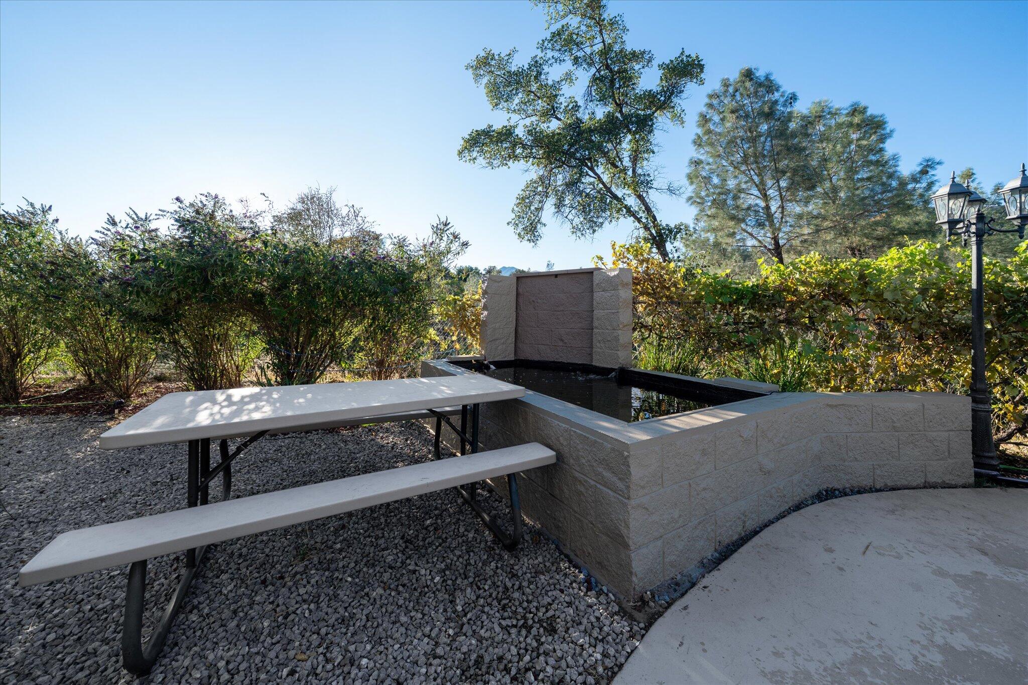 7870 Castle View Lane Redding, CA 96001 - Photo 45 of 65 a view of backyard with a large tree and wooden fence
