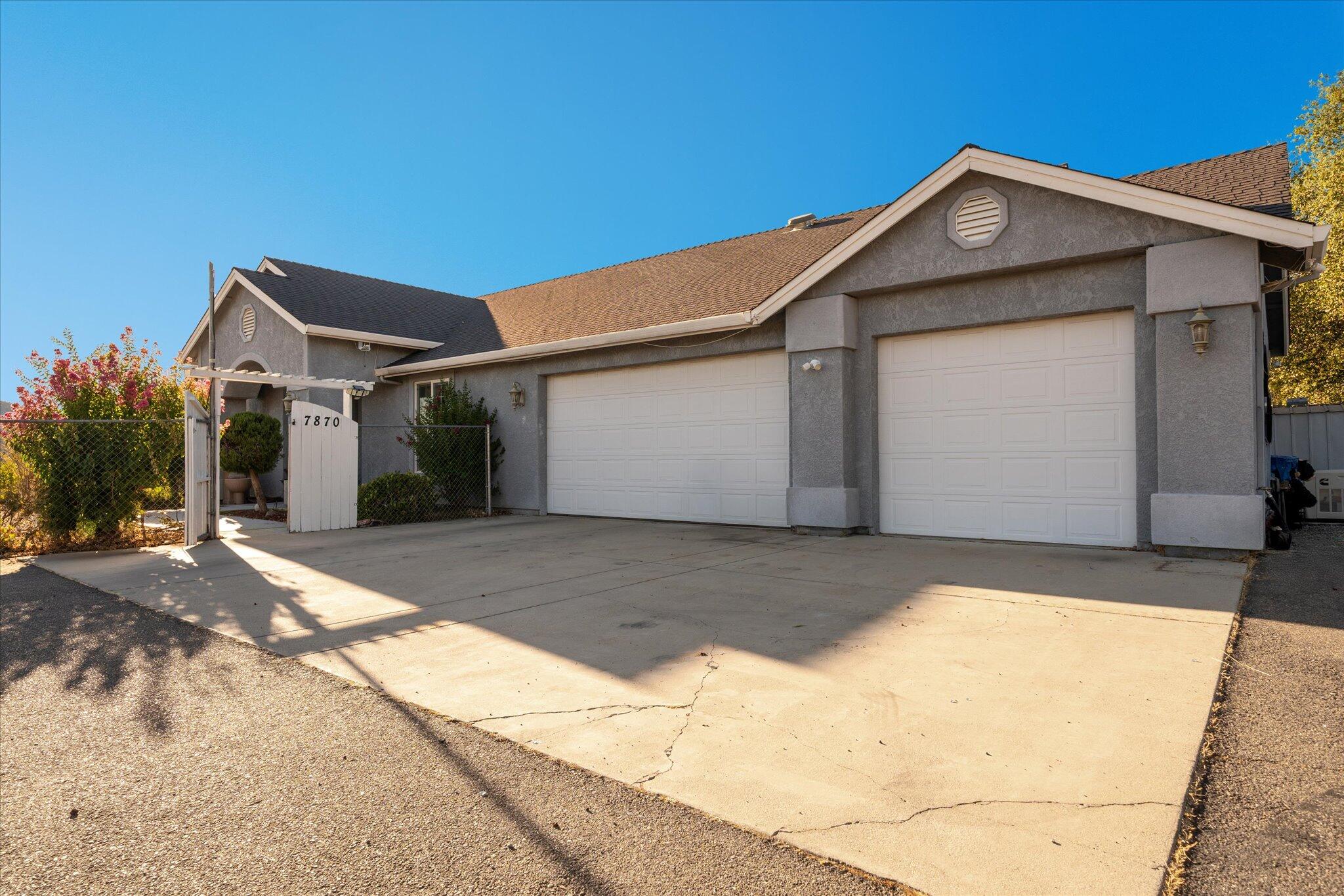 7870 Castle View Lane Redding, CA 96001 - Photo 55 of 65 a front view of a house with a yard and garage