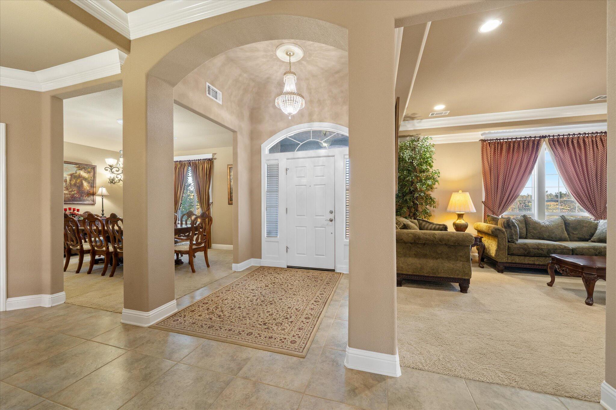 7870 Castle View Lane Redding, CA 96001 - Photo 7 of 65 a living room with furniture and a chandelier
