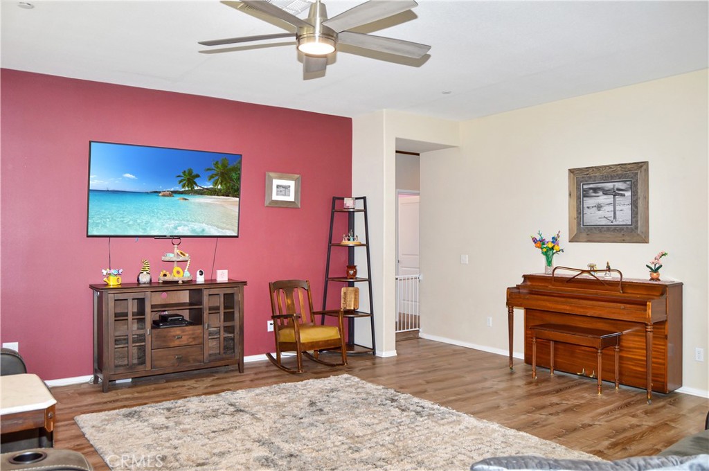 166 Fox Lane Calimesa, CA 92320 - Photo 13 of 76 Spacious Great-Room-Style Living Room with Fabulous Flooring, Ceiling Fan, and Backyard Views (TV screen is simulated)