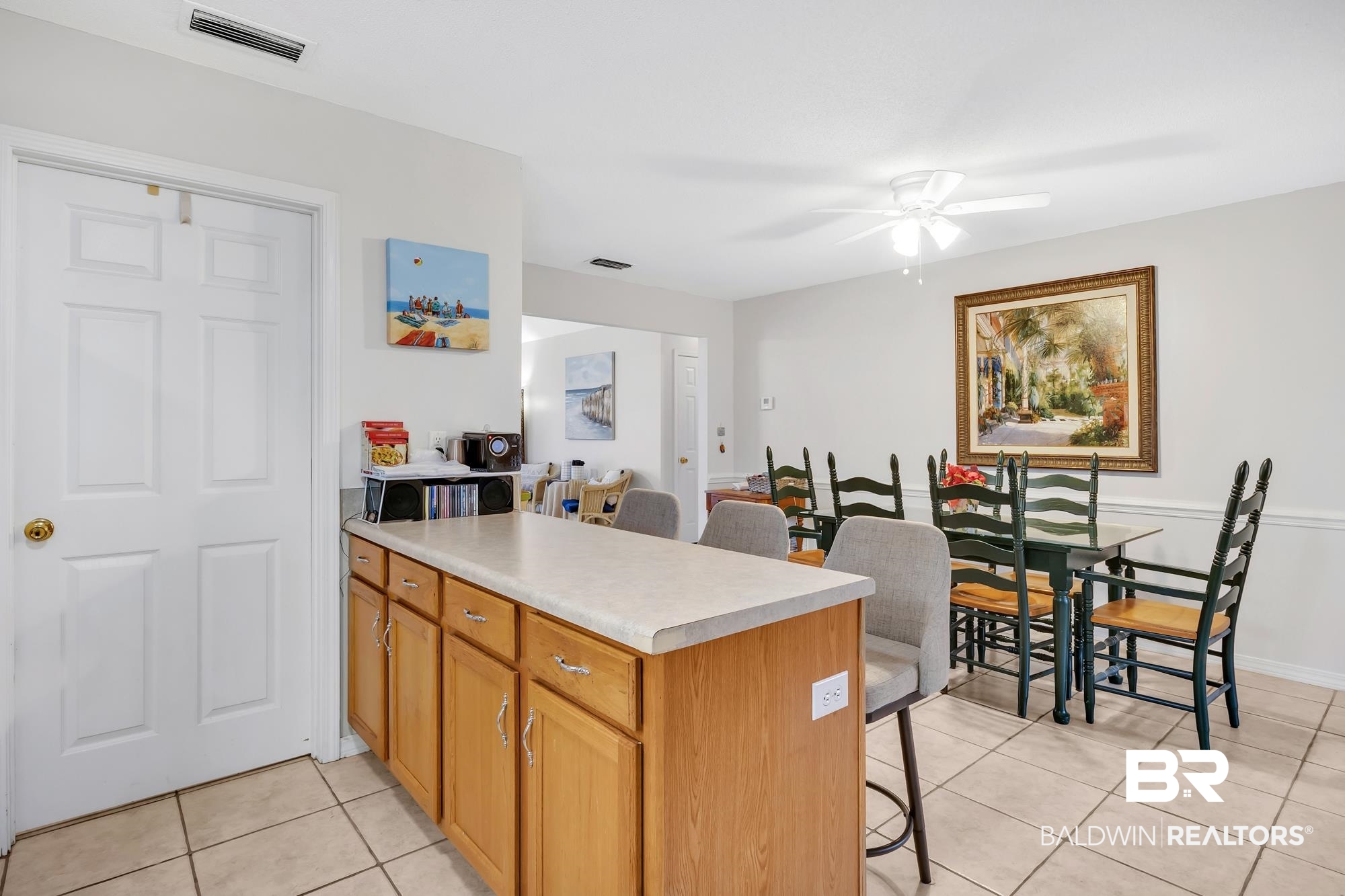 105 Cluster Oaks Court Foley, AL 36535 - Photo 16 of 26 Kitchen with a breakfast bar area, a peninsula, light tile patterned floors, light countertops, and ceiling fan