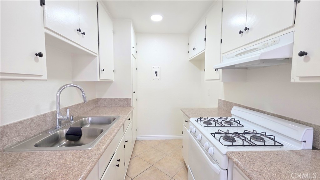 3733 Durfee Avenue, Unit 8 El Monte, CA 91732 - Photo 3 of 14 a kitchen with granite countertop a sink stainless steel appliances and cabinets