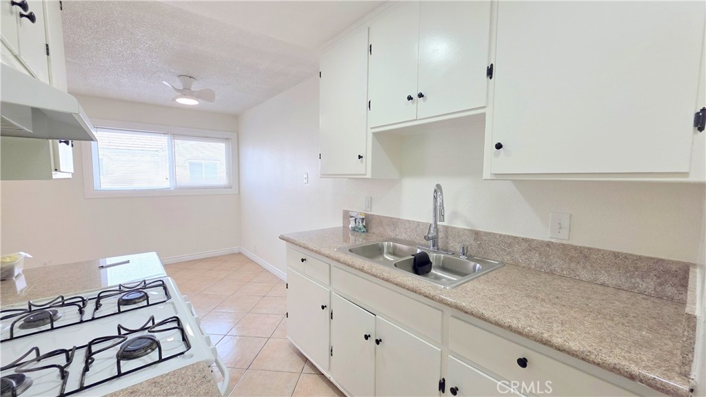 3733 Durfee Avenue, Unit 8 El Monte, CA 91732 - Photo 4 of 14 a kitchen with stainless steel appliances granite countertop a sink stove and cabinets