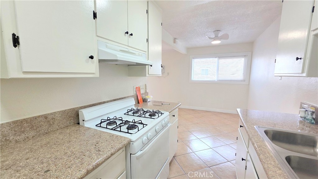 3733 Durfee Avenue, Unit 8 El Monte, CA 91732 - Photo 5 of 14 a kitchen that has a sink and a stove
