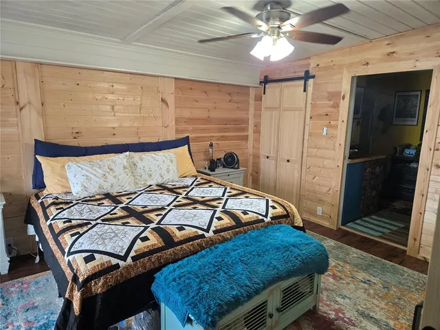 a bed sitting in a bedroom next to a window