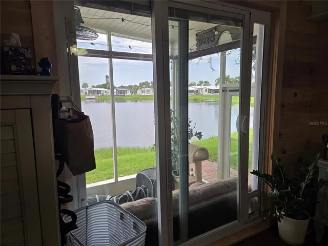 a living room with furniture and a floor to ceiling window