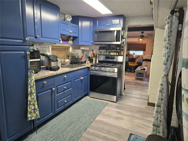 a kitchen with stainless steel appliances granite countertop a refrigerator a stove top oven a sink and dishwasher