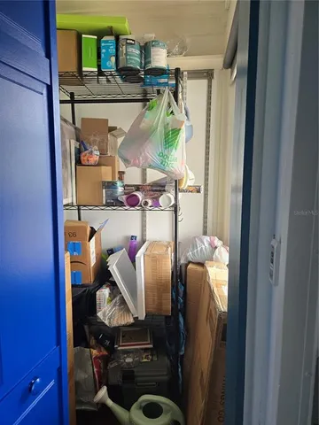 a view of storage and utility room with racks on the wall