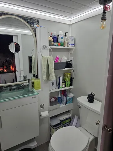 a bathroom with a sink a toilet and a shower