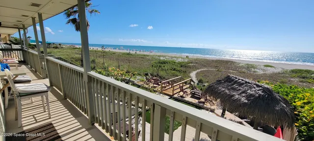 a view of a balcony with ocean view