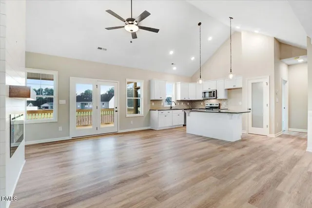 a view of kitchen with refrigerator and wooden floor