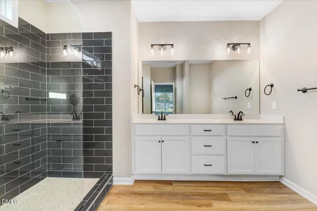 a bathroom with a tub a sink and a shower
