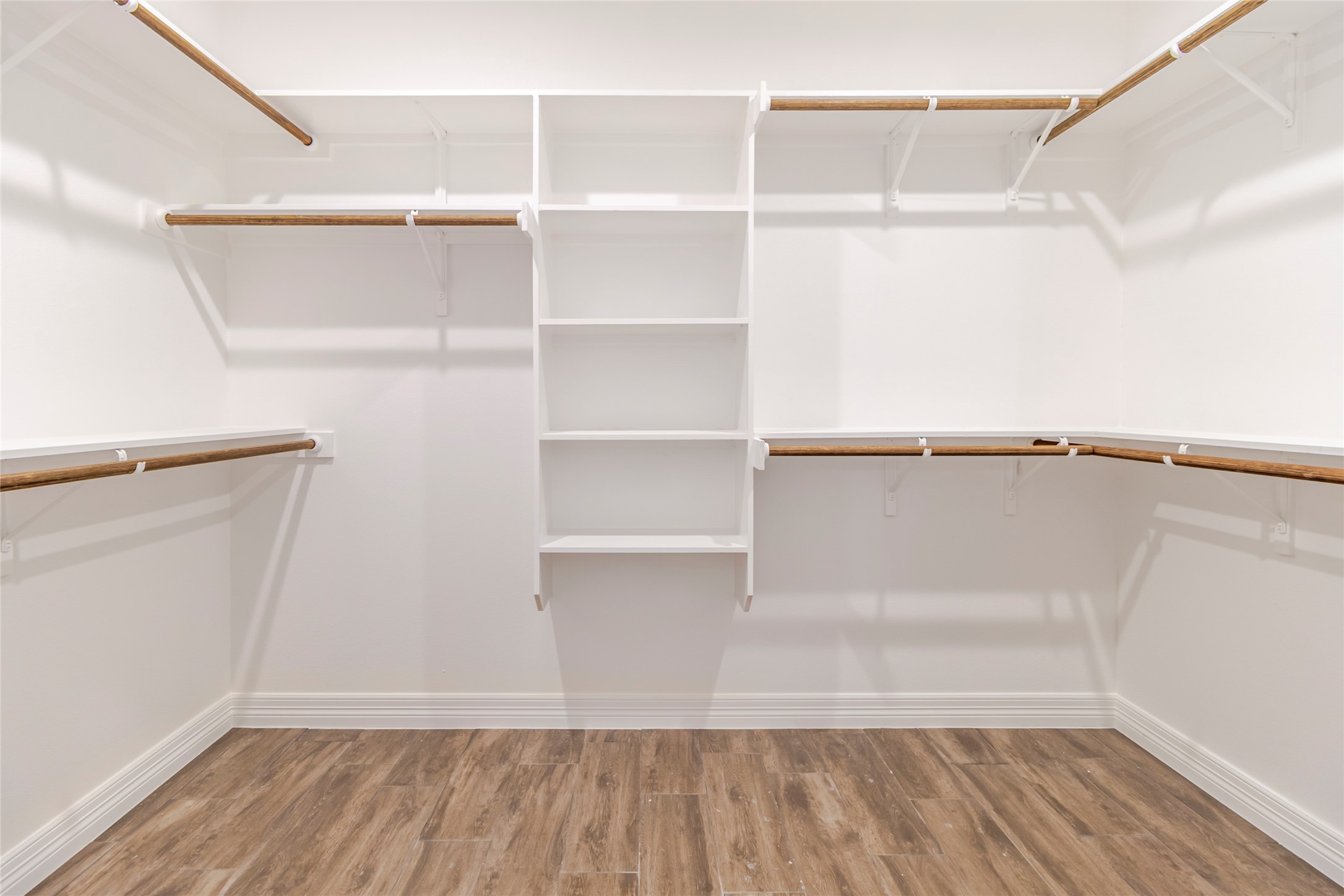 309 Myrtle Road Smithville, TX 78957 - Photo 12 of 17 Shelving and hanging space wrap around three sides of the walk-in closet, leaving the center open and usable.