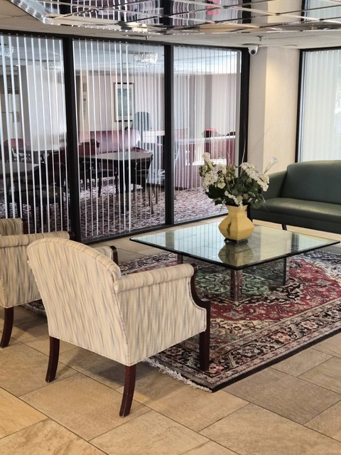 711 South River Road, Unit 704 Des Plaines, IL 60016 - Photo 2 of 15 a table and chairs in a balcony