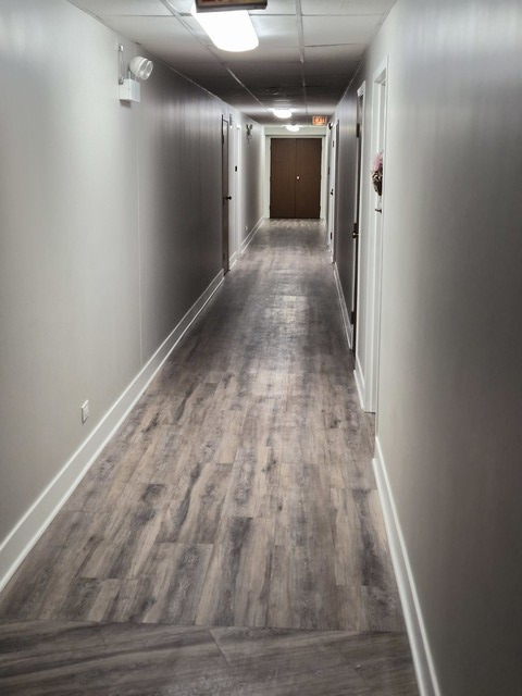 711 South River Road, Unit 704 Des Plaines, IL 60016 - Photo 3 of 15 a view of hallway with wooden floor