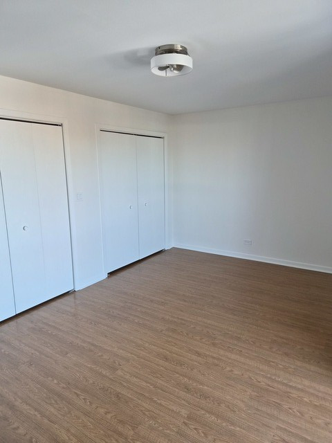 711 South River Road, Unit 704 Des Plaines, IL 60016 - Photo 8 of 15 a view of an empty room with wooden floor
