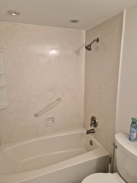 711 South River Road, Unit 704 Des Plaines, IL 60016 - Photo 9 of 15 a bathroom with a bathtub and a shower