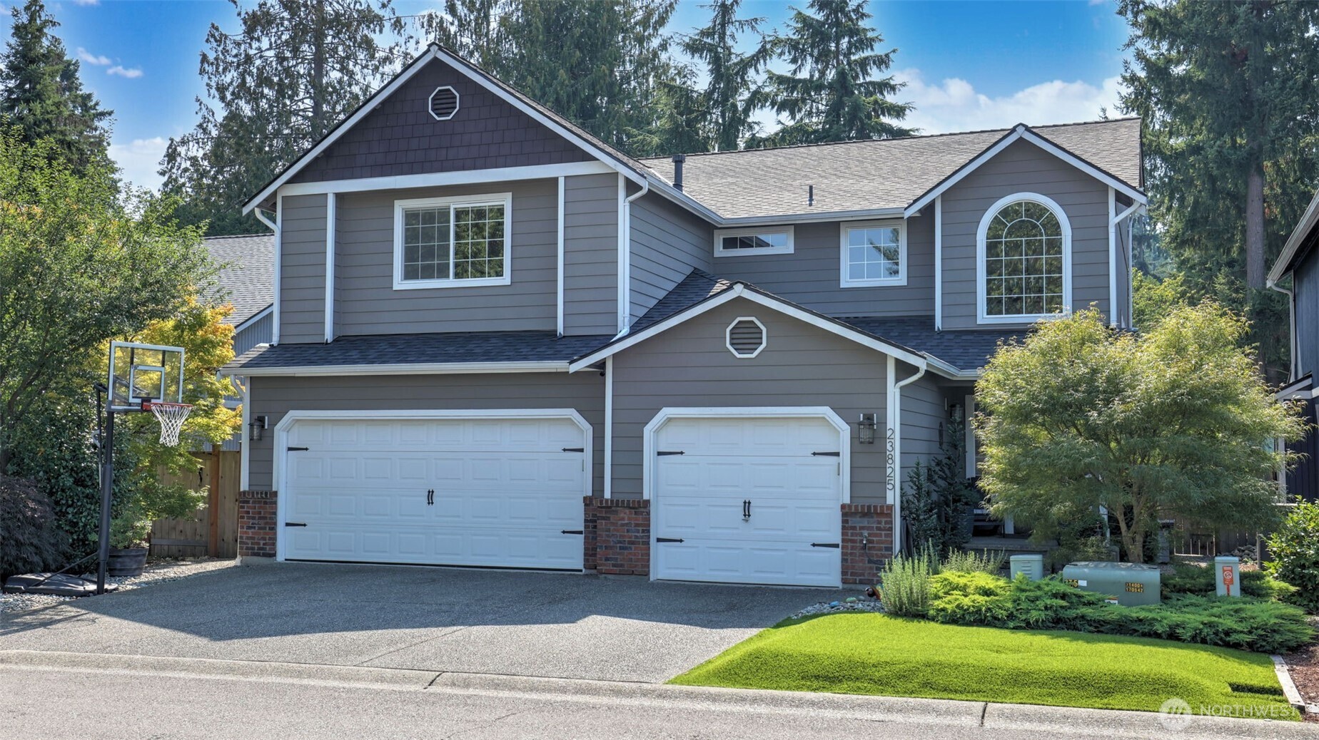 a front view of a house with a yard and garage