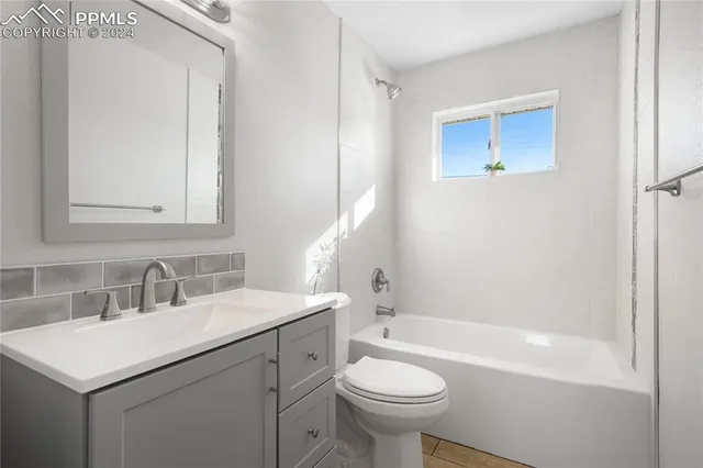 a bathroom with a sink mirror toilet and bathtub