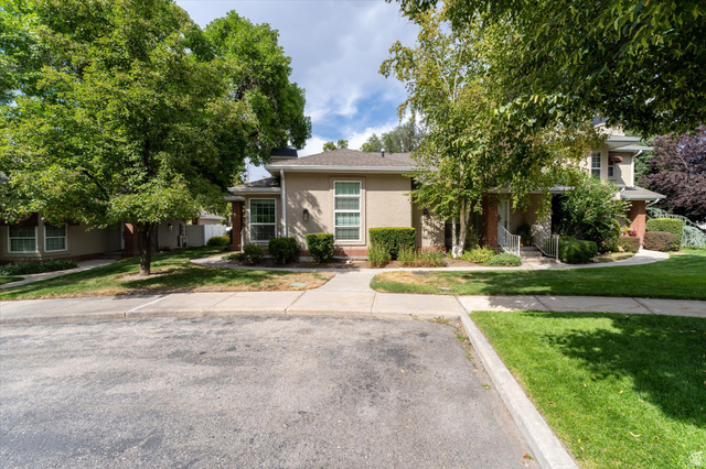 888 East 6895 South Midvale, UT 84047 - Photo 45 of 54 Well-maintained exterior with mature trees, manicured landscaping, and a welcoming walkway leading to the entrance.